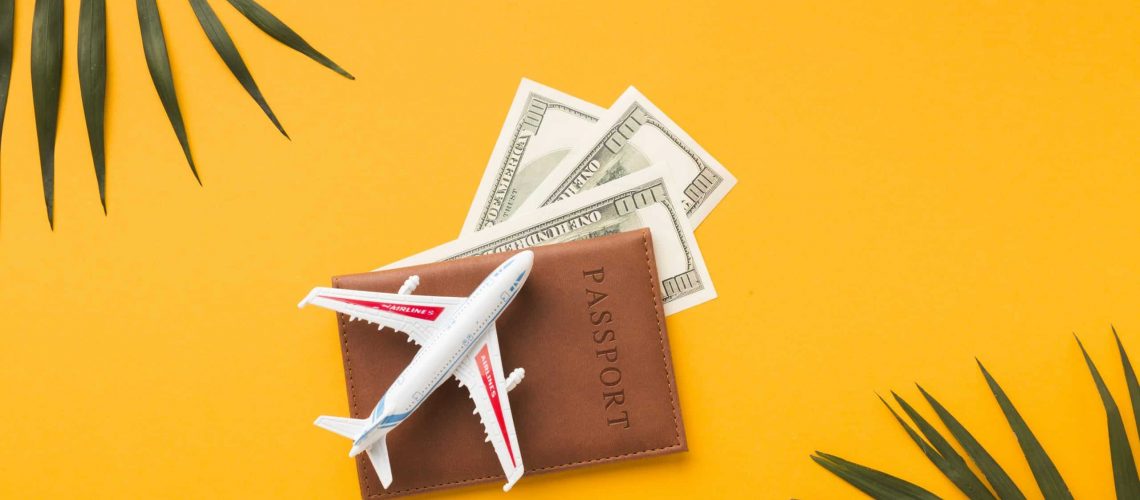flat-lay-passport-with-money-plane-figurine-top